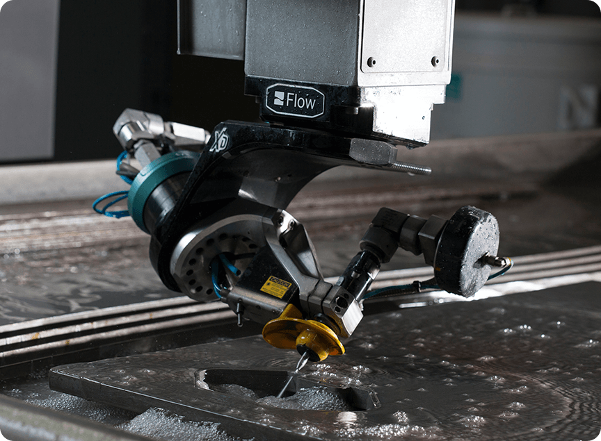 Dynamic Waterjet XD cutting head cutting material without heat affect