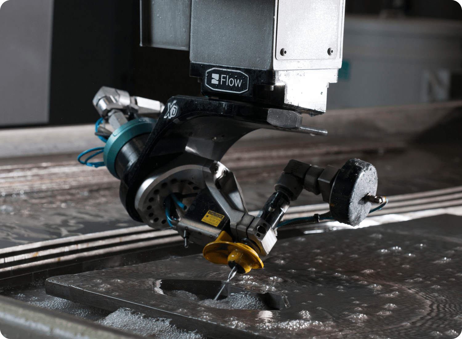 photo of waterjet cutting a metal sheet